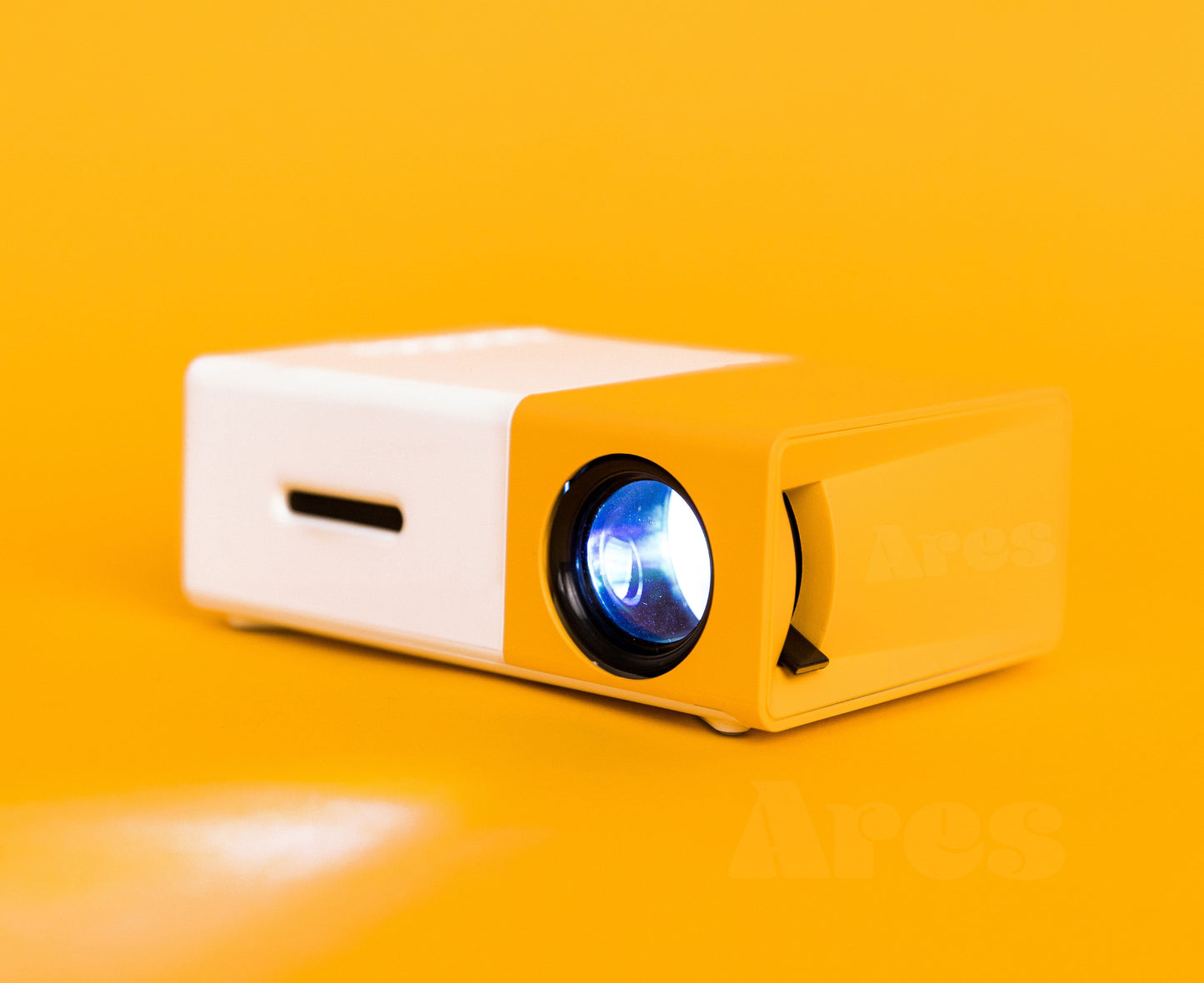 ultra HD mini projector displaying in a yellow background